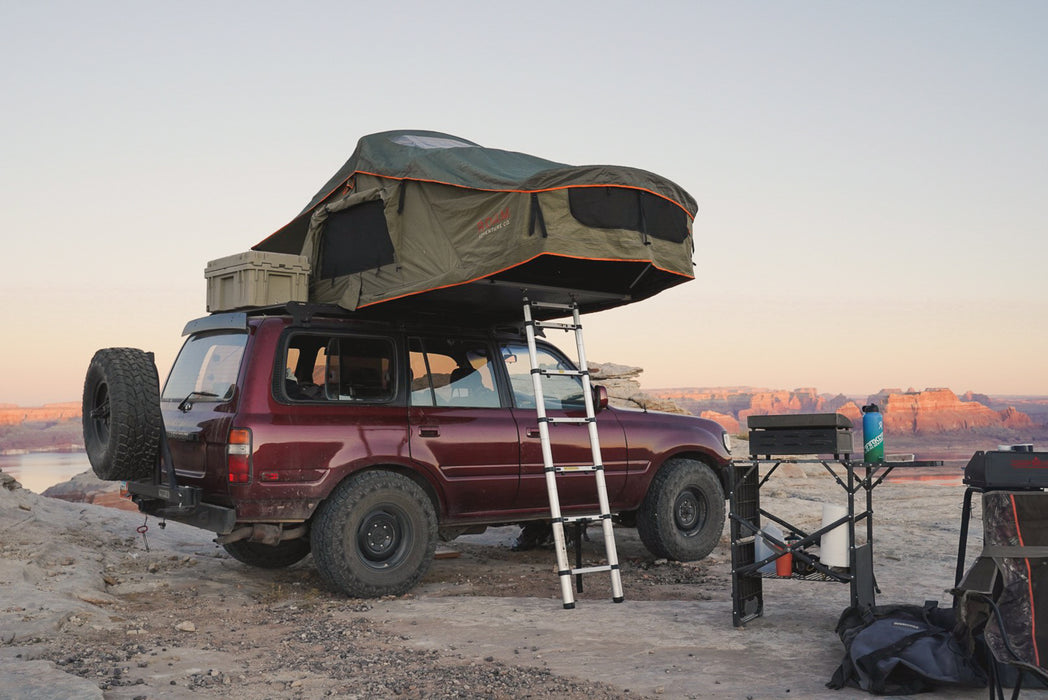 Vagabond Rooftop Tent in Forest Green Hyper Orange shown on Toyota Land Cruiser